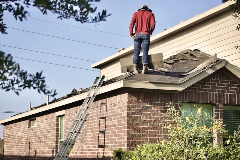 Professional roofer working on a residential roof in Tomlinson Mill